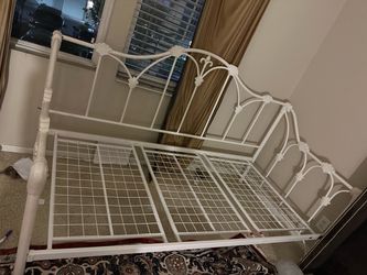 Twin bed with the mattress and the color is white