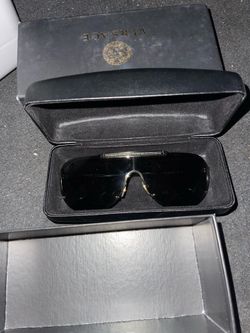 Versace shield sunglasses with the Greca bar on top .