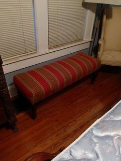 Bench with red fabric.