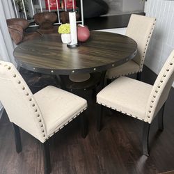 round dining table with 4 upholstered chairs