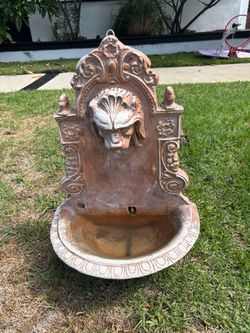 Terra cotta lion head water fountain