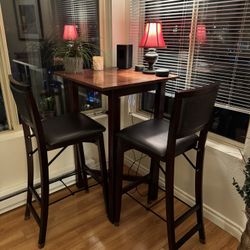 Bistro table that includes four padded chairs