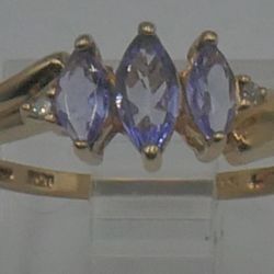 10kt yellow gold ring 1.4 grams size 7.25 2 small diamonds 3 light purple stones. 878746-3. 