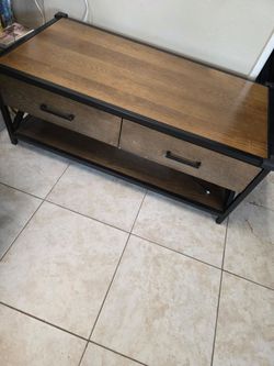 Heavy wooden table with steel edging and 2 wide drawers