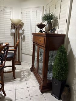 Thomasville Cabinet with Double Glass Doors and a drawer, glass bevel shelf with mirror in back.