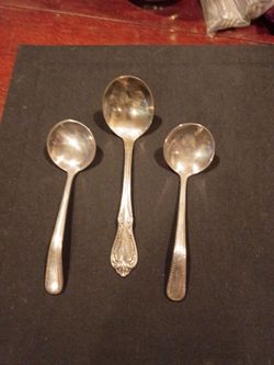 Three vintage soup ladles.