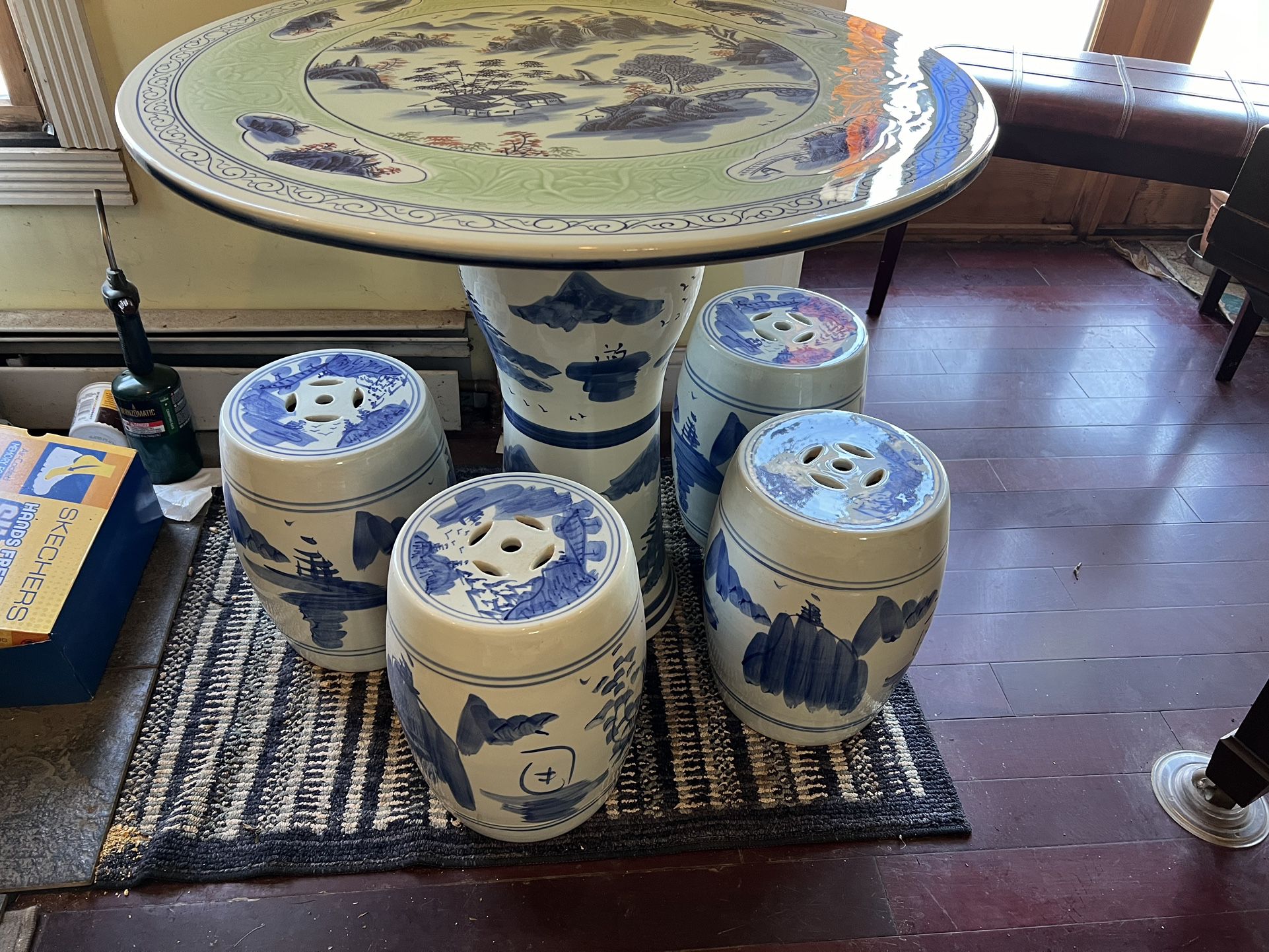 Ceramic round table and four ceramic stools