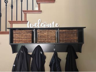 Black entryway hall tree and storage bench set with wall hooks