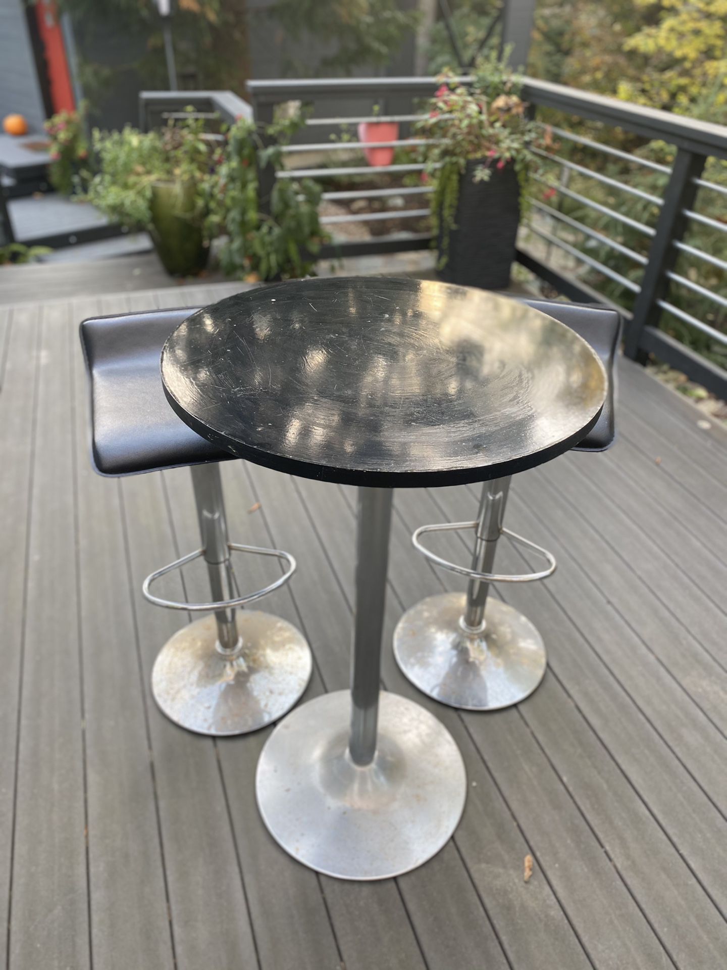 Bar height table and swivel stools