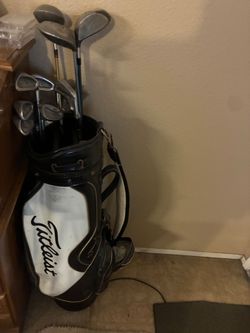 Titleist Golf bag and random clubs