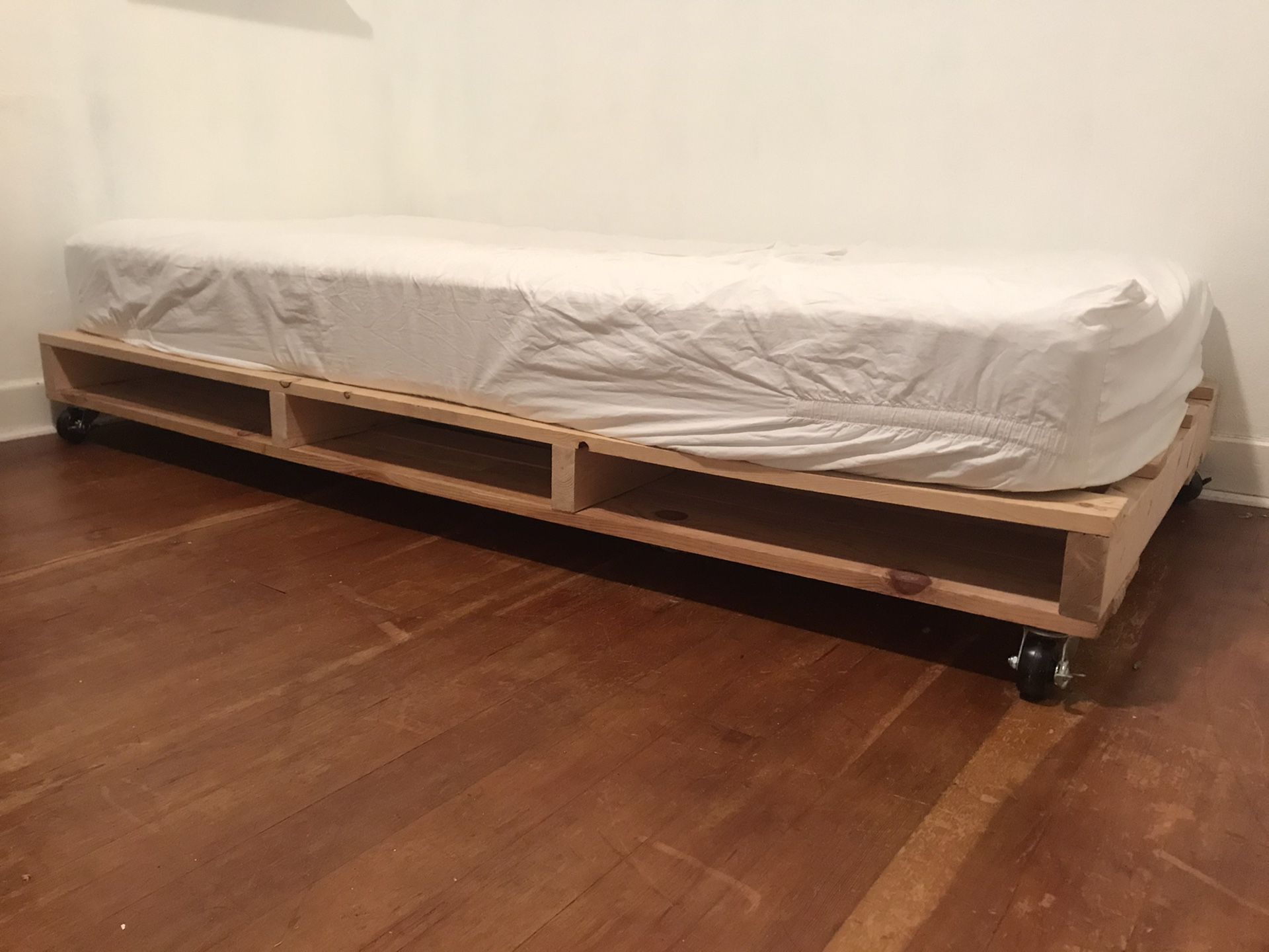 Twin bed frame (mattress not included) on casters with storage