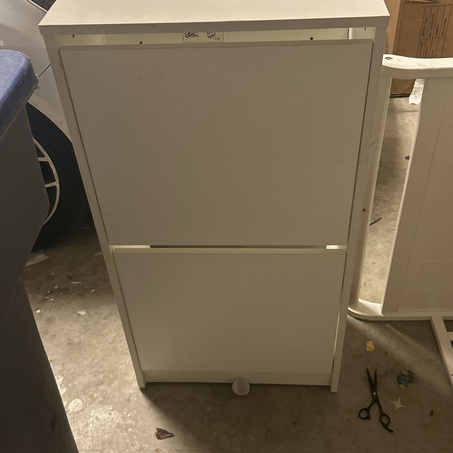 White Cabinet With Swing Drawers Great For Baby’s Room Next To A Changing Table