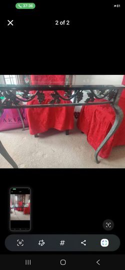 Glass and wrought iron table .