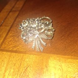 vintage Avon SP large flower bouquet brooch in a bronze-toned metal setting with smokey gray, clear, and amber rhinestones. 