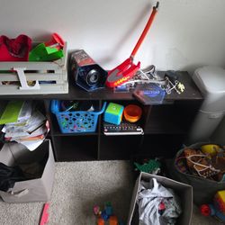 Two cubby shelves with pull out grey boxes 