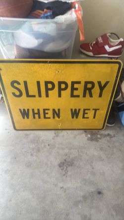 Vintage slippery when wet road sign