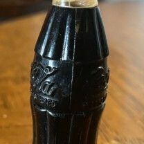 This is a vintage 1950s Coca-Cola bottle lighter, a collectible advertising item. 
