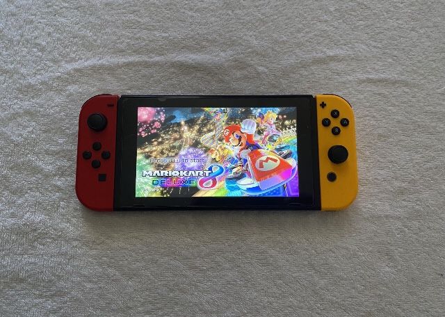 NINTENDO SWITCH + 125 SWITCH GAMES MARIO PARTY,MARIO KART,ZELDA,MORTAL KOMBAT and More