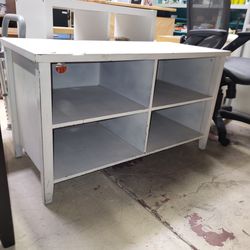 Rustic storage table. Has four cubes. Stop by to inspect