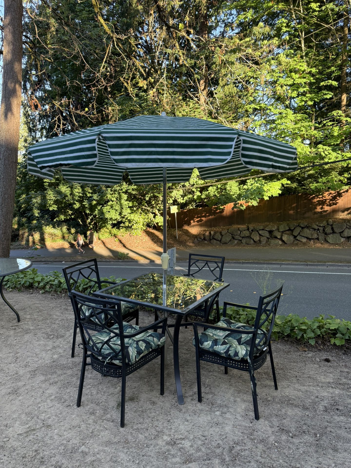 Nice aluminum glass table with four chairs, umbrella, and pads