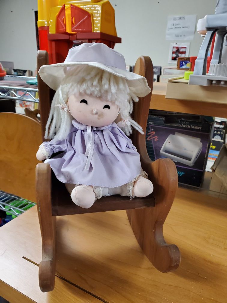 Wind up doll in a rocking chair
