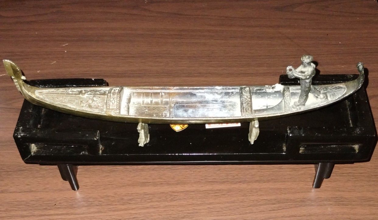 Antique Metal Sculpture On Wood