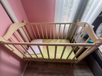 Baby and Toddler Bed / Crib with a swing and a drawer
