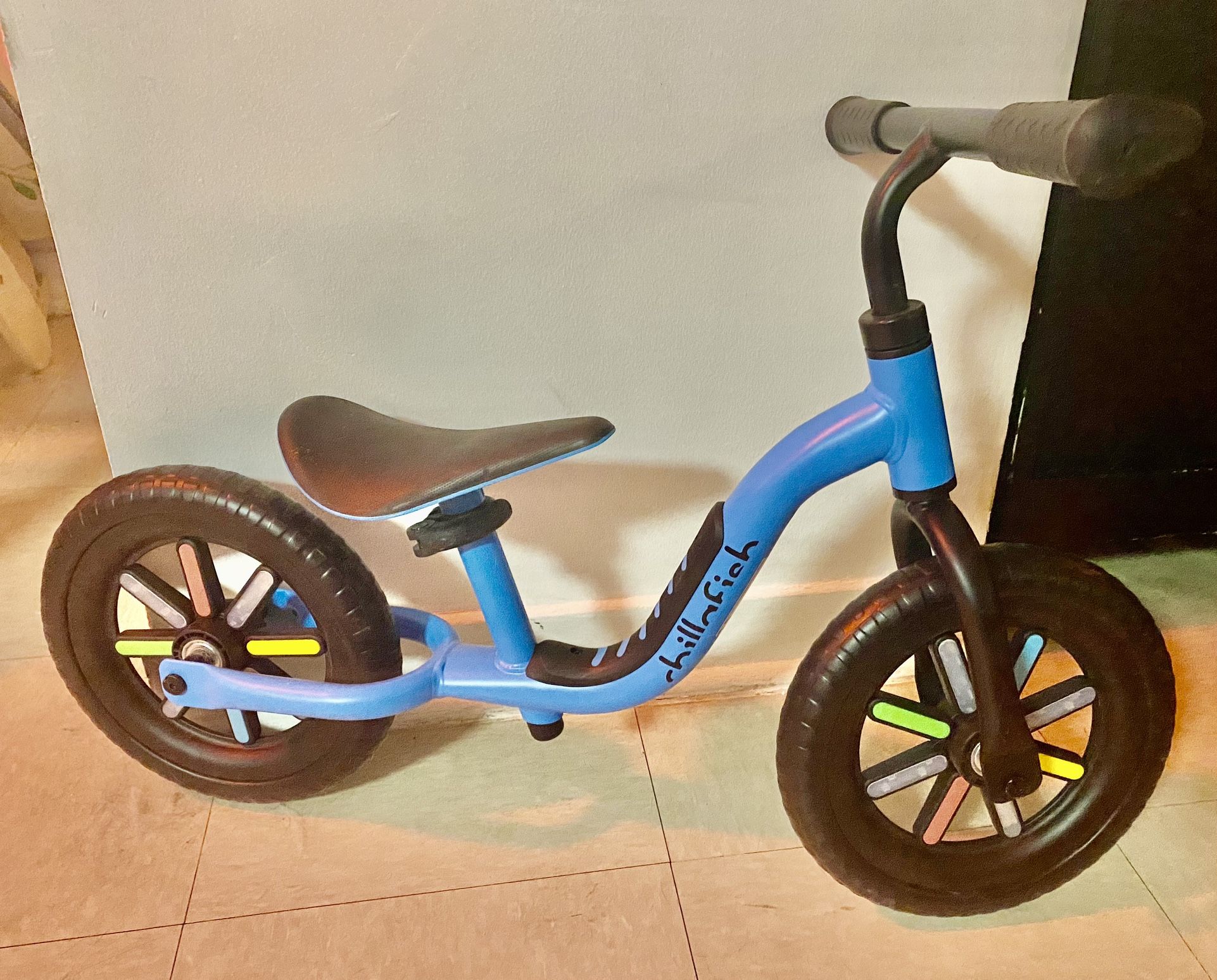 Infant/toddler chillafish blue balance bike with rainbow wheels