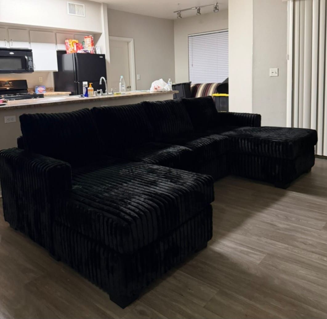 corduroy fur like sectional sofa with double chaise and two accent pillows.