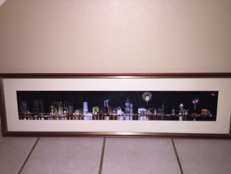 Framed photo of city lights and firework show on water