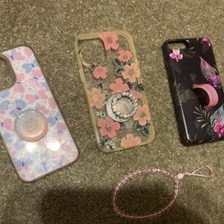 3 Different Phone Cases And A Phone Charm. 