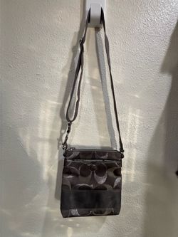 Coach Signature Metallic Swingpack (also called a Swing Pack or Crossbody Bag) in the gray/silver metallic colorway.