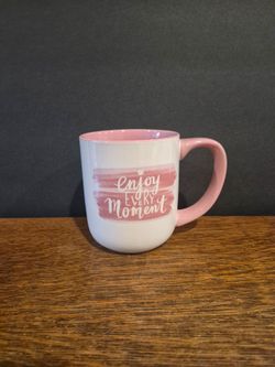 White Ceramic Coffee Mug with a pink handle, a pink interior, and a pink watercolor brushstroke design featuring the phrase "Enjoy Every Moment".