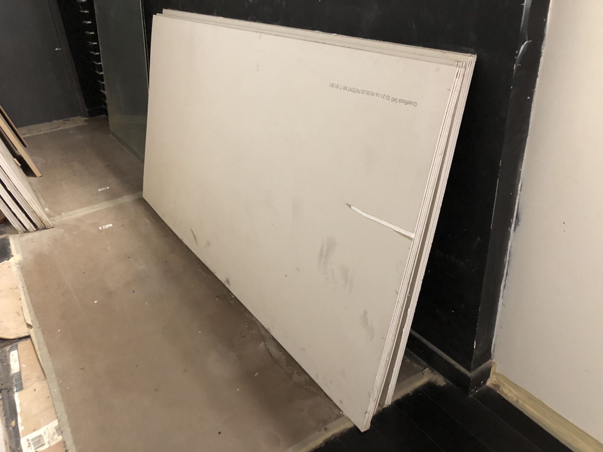 QuietRock 545 - 1 and 3/8” thick specialty sound damping drywall panels. Cheap!
