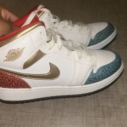 Air Jordan 1 Mid SE “White / Metallic Gold” with Elephant Print.