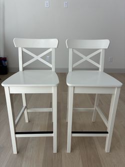 A pair of counter stools - white