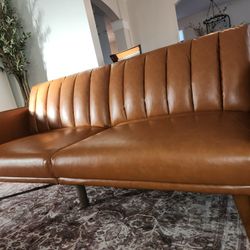 New assembled caramel color futon faux leather has a scratches on side of hand rest selling as is 