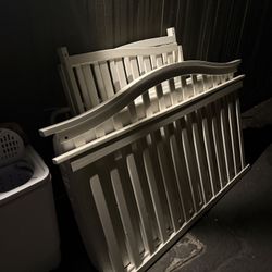 White-painted wooden crib frame, mattress, box springs, and screws for assembly.