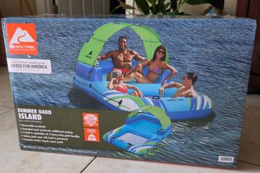 New in box Ozark Trail Summer Oasis Island inflatable float. Has removable sunshade and extended mesh section for additional seating. Has 4 built-in c