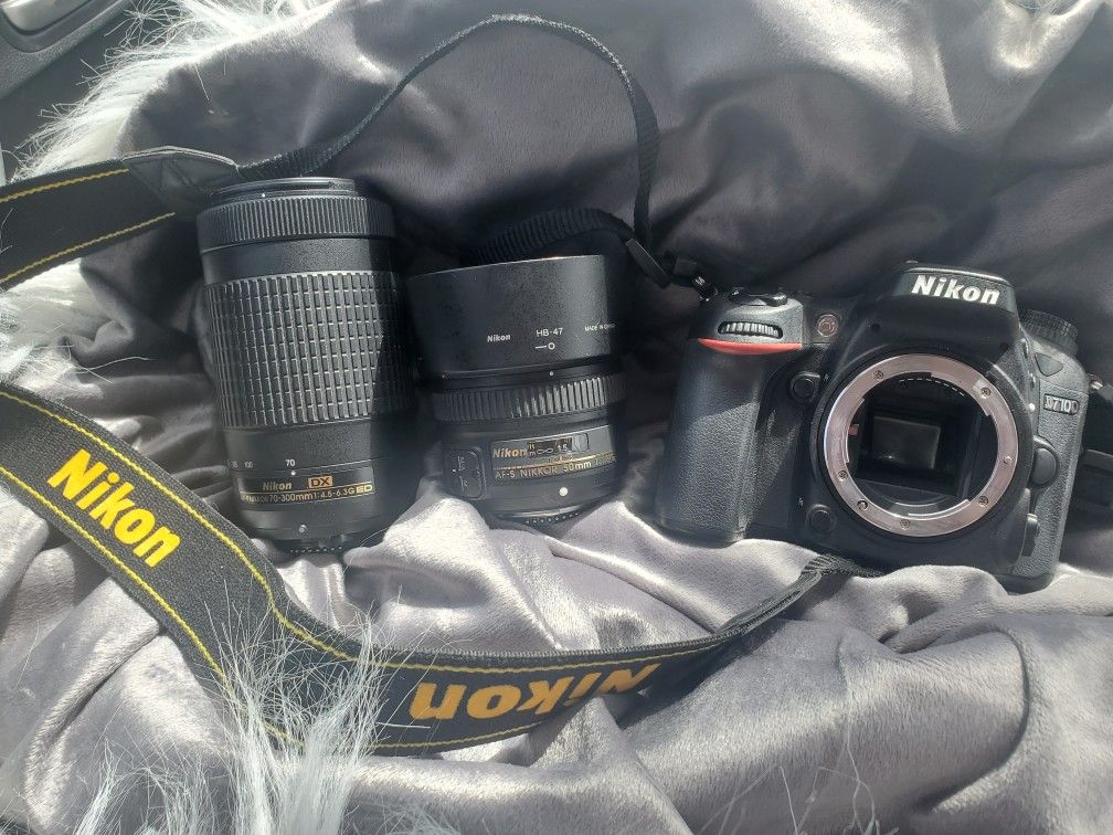 Nikon Camera, 2 Lens, Battery Charger. Strap.