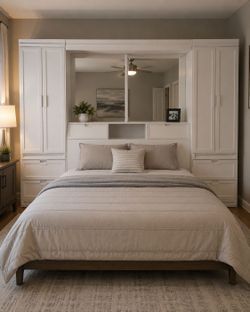 Queen headboard wall unit with storage wardrobe and work units on each side of the bed more cabinets and storage areas in the center dimmable lights a
