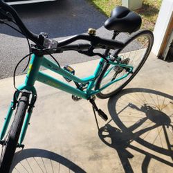 Womens Specialized light teal bike with accessories