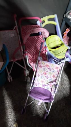 Doll strollers $5 each pinkp or purple the pink one in back with canopy top is $20