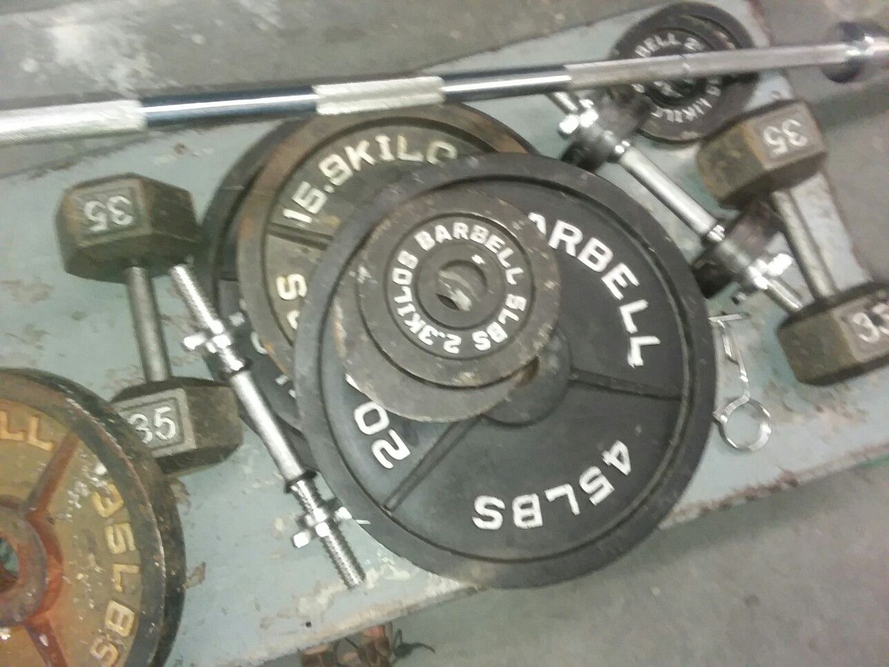 250 lb Olympic set with bar plus extras including dumbbells and bench heavy duty