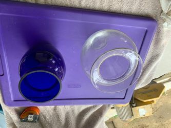 2 glass vases. Blue vase measures 8” tall x 5” wide