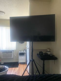 Samsung smart tv on black tripod
