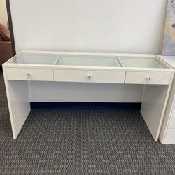 Makeup table with glass top, three drawers with crystal knobs.