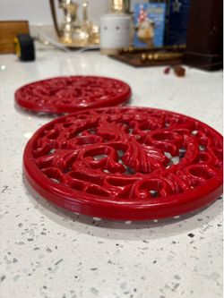 Two vintage cast iron trivets