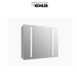 Kohler Verdera Lighted Three Door Medicine Cabinet with Nine Shelves, Built-in Outlets, and Flip Out Magnifying Mirror