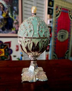 Vintage 2002 mint green enameled and silver-plated rotating musical Egg. 13"×8"